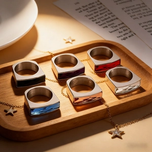 Macro detail of rectangular cut crystal rings in multiple colors on a wooden tray