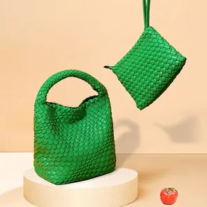 Bright green woven leather handbag set with matching wristlet in minimalist design