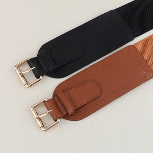 Close-up of black and brown elastic wide belts with golden square pin buckles