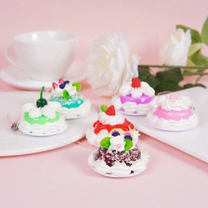Miniature realistic dessert charms with pink cream and fruit details for bag keychain