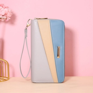 Macro shot of tricolor geometric faux leather clutch wallet with gold zipper and wristlet