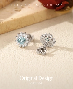Macro detail of sunflower-shaped S925 silver stud earrings with light blue moissanite