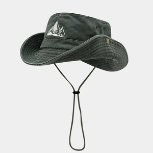 Detail of mountain embroidery and metal eyelets on dark grey-green hiking sun hat