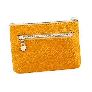 Detailed macro view of orange litchi grain leather purse with heart zipper pull