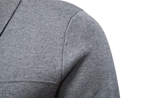 Detailed close-up of grey knitted men's cardigan showcasing shoulder stitching and texture