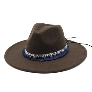 Close-up of brown wool felt fedora with ornate blue tasseled band and sequin trim details
