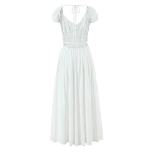White backless maxi dress with puff sleeves and waist tie detail in a clean flat lay
