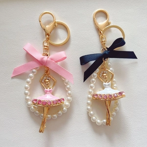Detail of ballet dancer keychains with pink rhinestones, faux pearls and silk ribbons