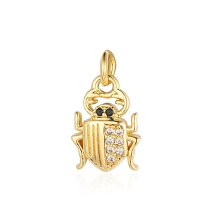 Detailed close-up of a golden beetle pendant with sparkling inlaid zircon gemstones