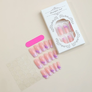 Flat lay of pink and purple floral press-on nails set with files and adhesive tabs