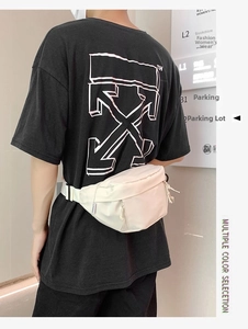 Detail of off-white crossbody bag featuring durable nylon fabric and plastic buckle strap