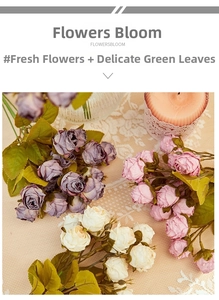 Flat lay of retro purple and pink artificial roses on lace with vintage candles
