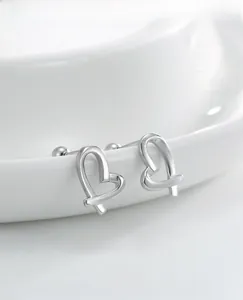 Macro detail of S925 sterling silver irregular open heart stud earrings with ball backings