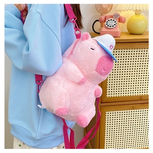 Detailed back view of a pink plush capybara backpack with a blue baseball cap accessory