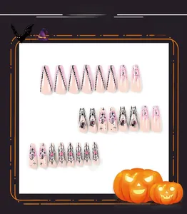 Detail view of pink Halloween press-on nails with spider webs and stitch patterns