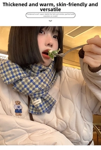 Detailed blue and yellow plaid scarf featuring soft knit texture on a model during brunch