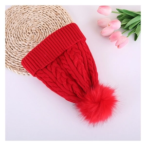 Winter chunky cable knit beanie hat with faux fur pom pom in vibrant red for women