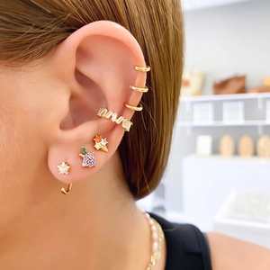 Close-up of S925 needle fruit earrings with zircon cherry and pineapple on model ear