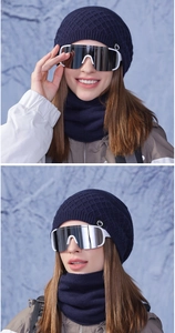 Detail of navy knit beanie and neck warmer set showing texture on a model in snow