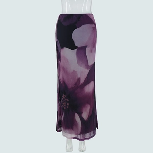 Detail of elegant purple floral print and sheer mesh texture on long flowing skirt