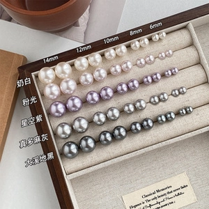 Detail showing five colors and five sizes of lustrous pearls from 6mm to 14mm