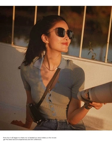 Flat snake bone titanium steel necklace shown with a blue polo shirt and sunglasses