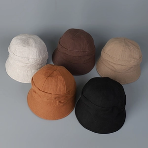 Linen bucket hats displayed in beige, coffee, khaki, orange, and black colors