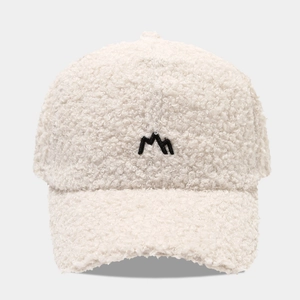 Close-up of thick off-white fleece baseball cap with black mountain peak embroidery