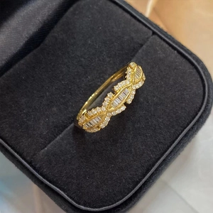 Primer plano detallado de anillo dorado con diamantes baguette en estuche de joyeria