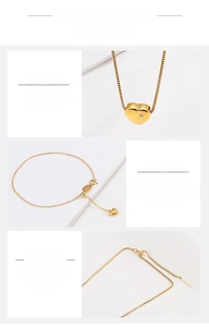 Detail of gold heart pendant necklace in titanium steel with polished finish and cubic zirconia