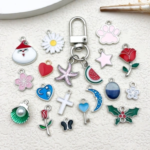 Detailed view of colorful enamel alloy charms featuring a pink starfish on a metal ring clasp