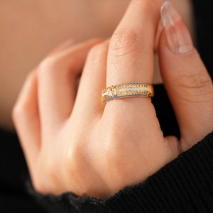 Macro detail of 18k gold plated ring featuring white enamel and sparkling zircon stones