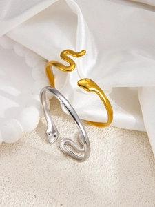 Detailed close-up of 18k gold and silver snake bangle showing sleek serpent head textures