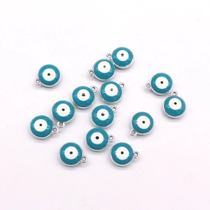 Flat lay of multiple blue evil eye beads with silver metal edges for jewelry making