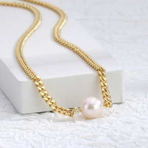 Chic gold cuban link necklace featuring a single freshwater pearl on a minimalist stand