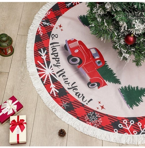 Detail of linen Christmas tree skirt with red truck motif, snowflakes and white tassels