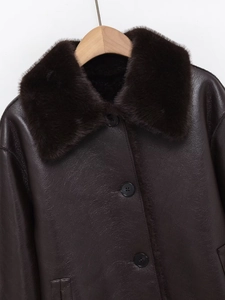 Detail of premium brown faux leather texture and fluffy fur collar on winter jacket