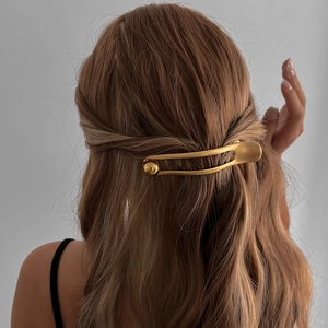 Elegant gold alloy hairpin with pearls shown on model in a minimalist modern style