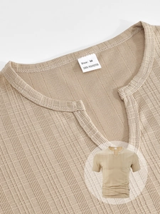 Detail of khaki V-neck men's shirt showing 100% polyester vertical striped fabric texture