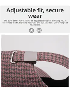 Detail view of pink and grey houndstooth cap with adjustable metal buckle on the back