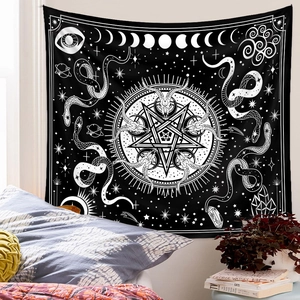 Detail of occult black tapestry with white star and moon icons on a bedroom wall