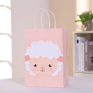 Pink cartoon sheep paper gift bag with white twisted handles on a clean white desk
