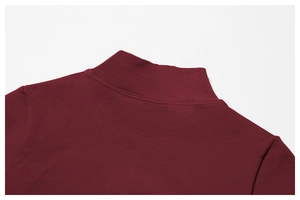 Macro shot of burgundy seamless yoga jacket featuring a ribbed mock neck and fine knitting