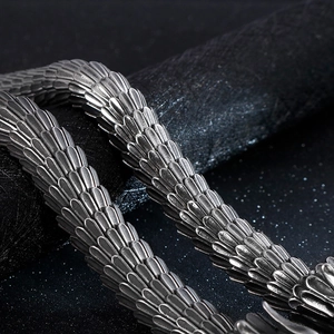Macro detail of vintage dragon scale pattern on stainless steel cast bracelet