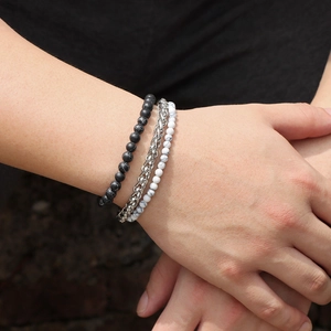 Close-up of a 3-piece set featuring matte black beads, silver chain, and marble bead bracelet