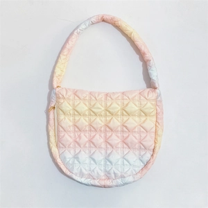 Detailed view of pink gradient cloud bag featuring quilted fabric and soft puffy texture