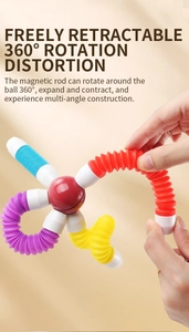 Detail showing hand stretching colorful flexible tubes of a magnetic building block toy
