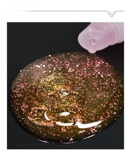 Macro detail of glossy double-layer rainbow lip gloss gel with sparkling pink and gold glitter