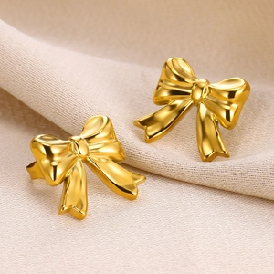 Macro shot of gold bow knot stud earrings in 18K gold plated stainless steel
