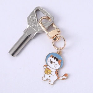 Close-up of hip-hop cartoon cat enamel keychain with space helmet and golden clip